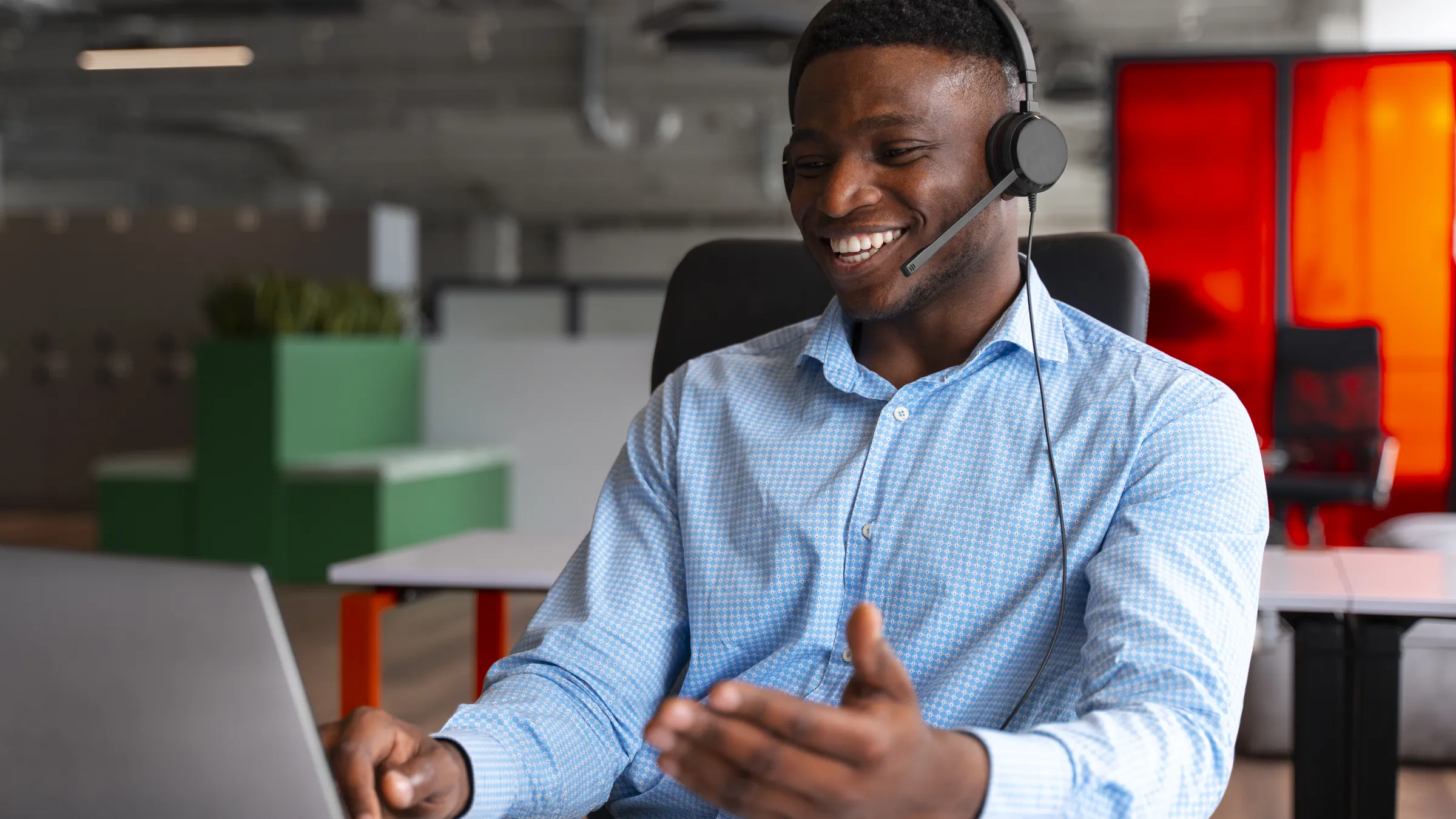 A help-desk agent with a headset helping a caller