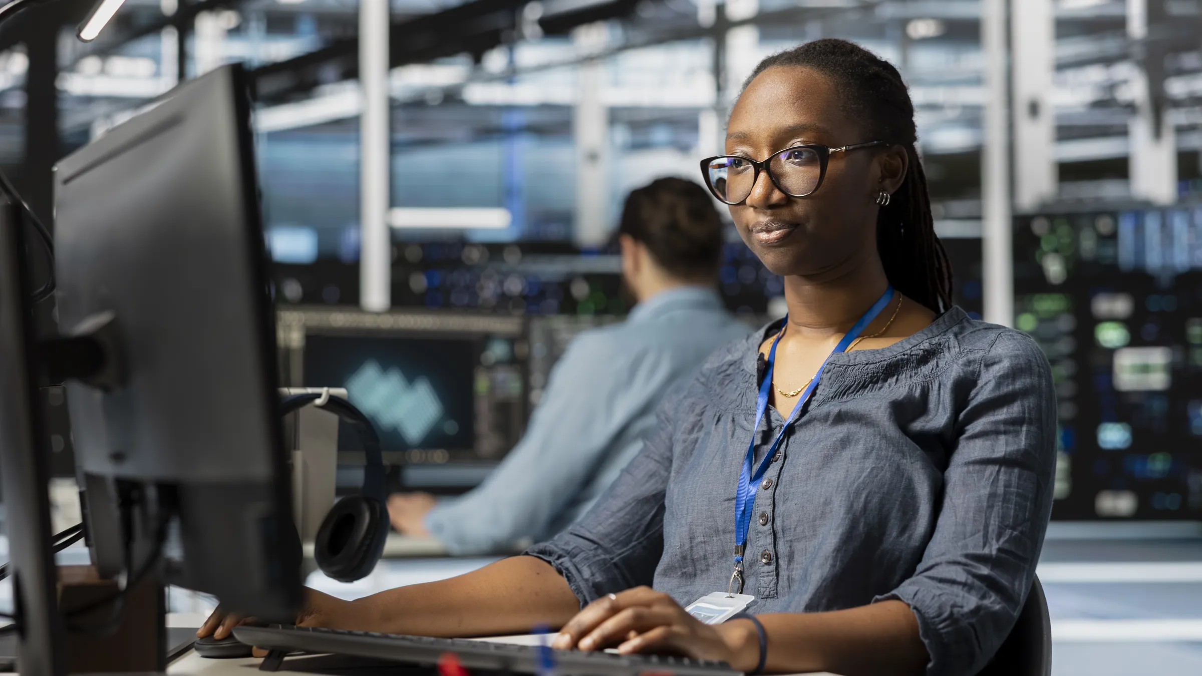 An engineer reviewing system logs at her workstation